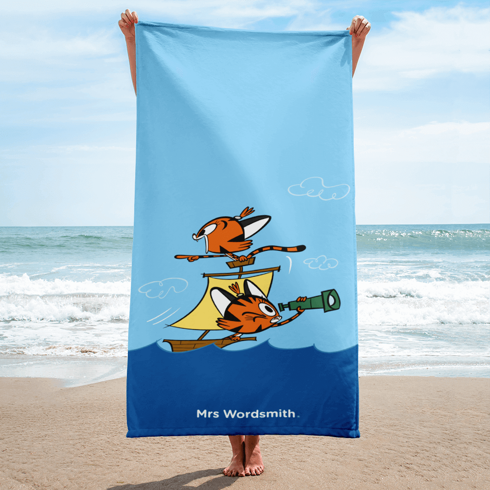 Beach towel with cartoon pirate ship on the beach.