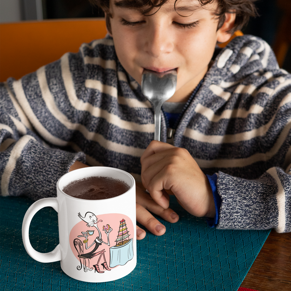 Boy enjoying Scrumptious Mug with cartoon image.
