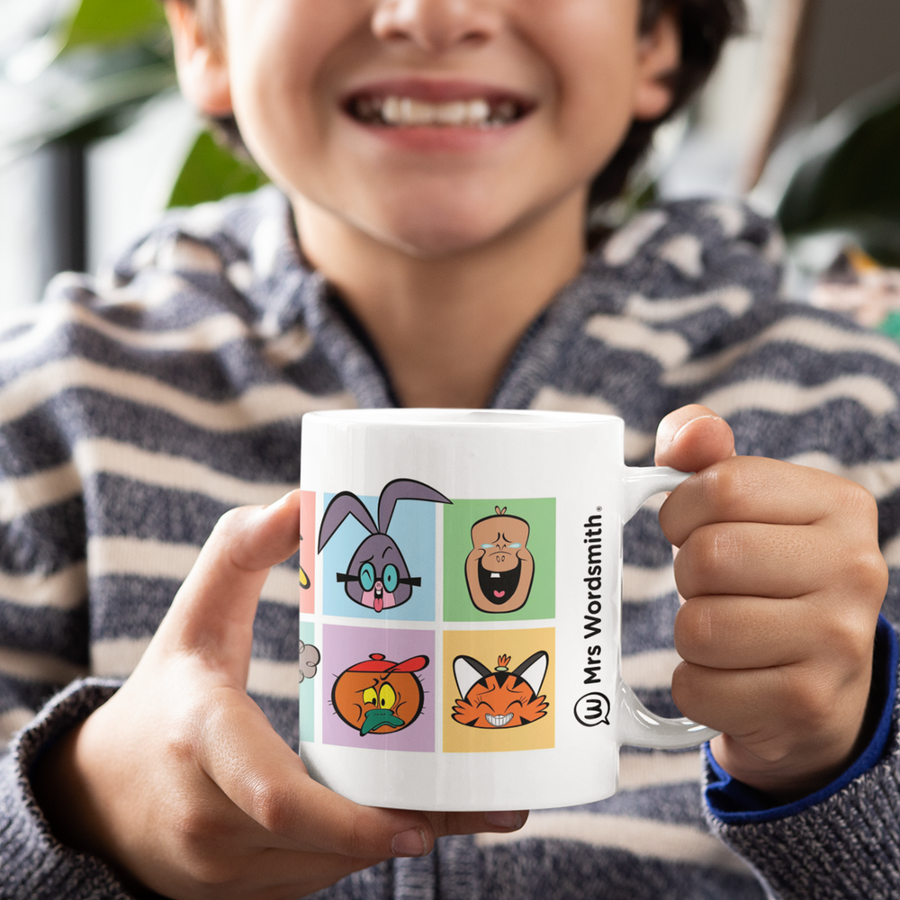 Child holding The Gang's All Here mug with cartoon characters.