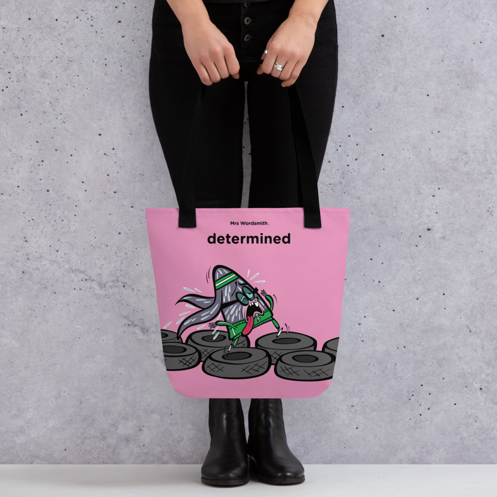 Black 15x15 determined all-over print tote bag front view.