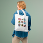 Character cotton tote bag held by person
