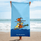 Beach towel with cartoon pirate ship on the beach.